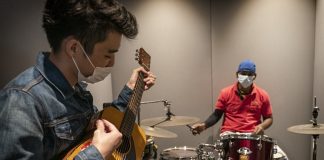Performing Pop Music Offers Stress Relief and Confidence-Building for Youth Mr David Choo, 30, champions REACH Rock Steady, a year-long programme that uses music to build confidence for youths through practice and performance.