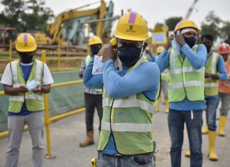 Pragmatic, On-site Innovations to Keep Workers Safe Mr Rajendran Samidurai, 35, from India, puts on the reusable mask from Temasek Foundation. These masks are being distributed to all who work in the built environment (BE) sector